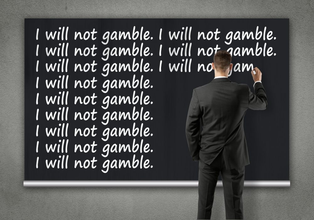 businessman writing on wall - I will not gamble